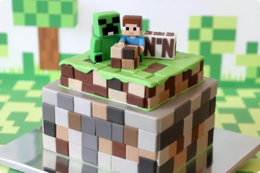 Minecraft cake with pixelated frosting, fondant Minecraft characters (Creeper, Steve, TNT), and block designs for a gaming celebration